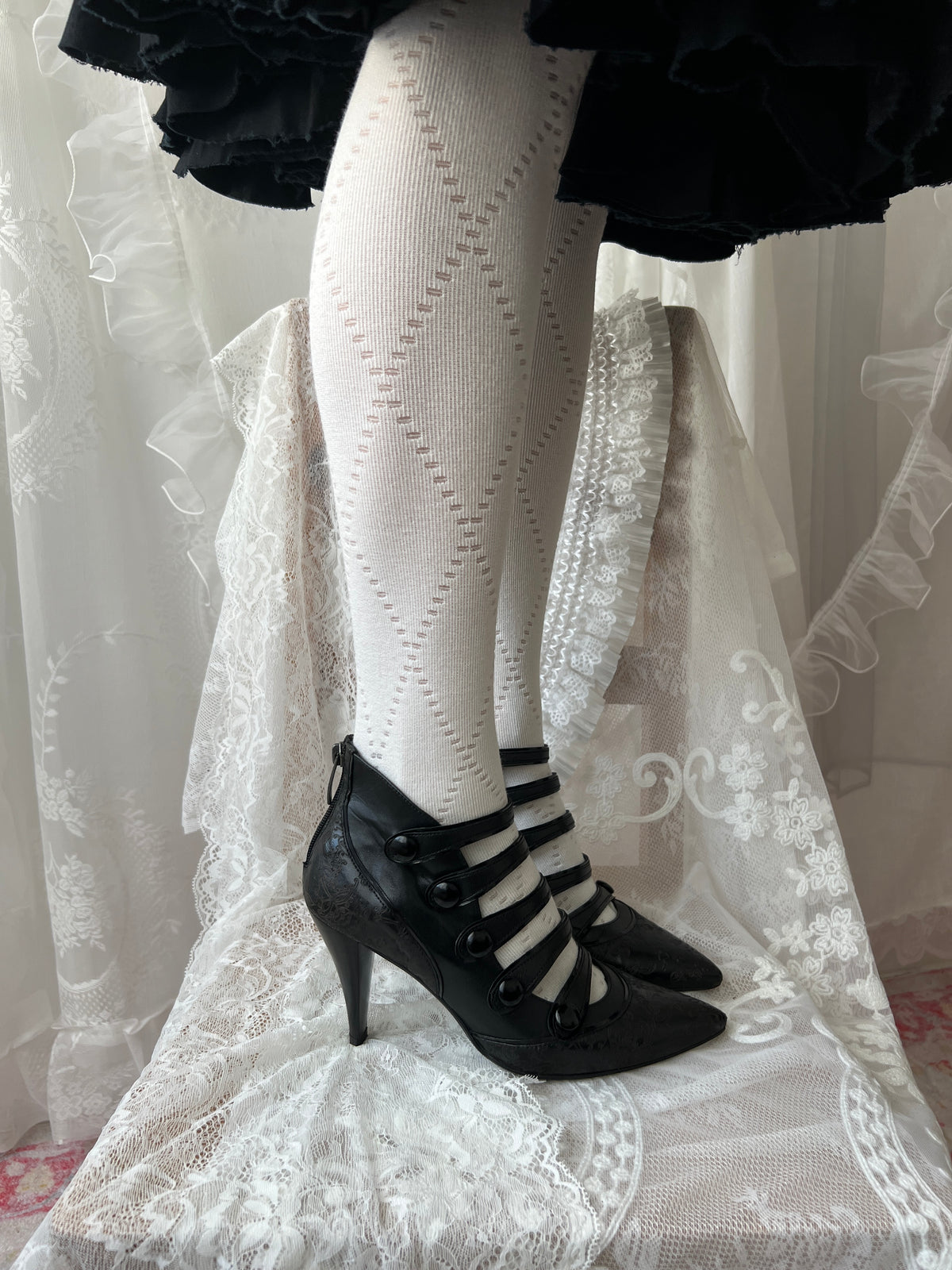 Black leather kitten heels with pointed toe and button details
