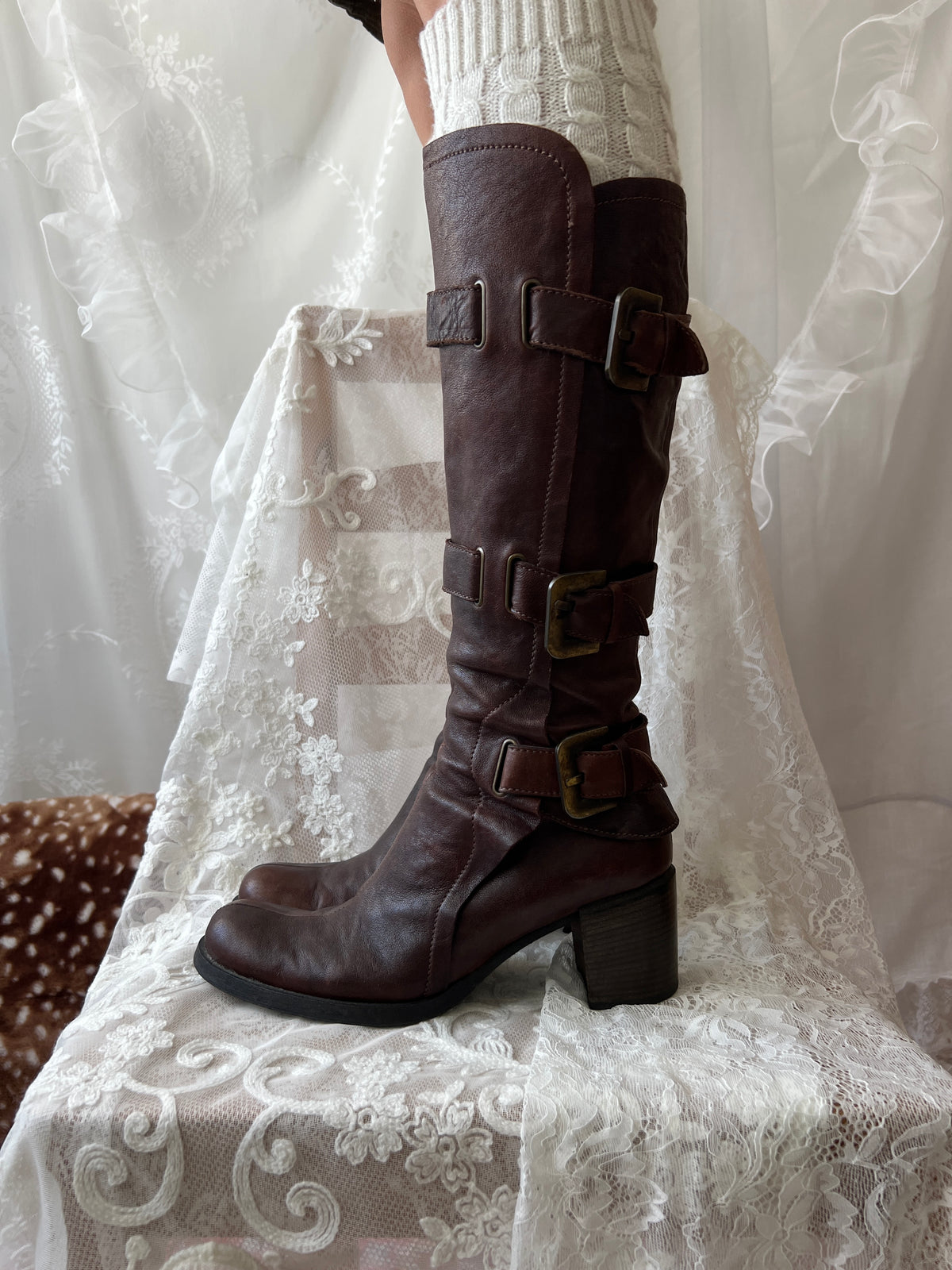 Brown knee high boots with buckle detail