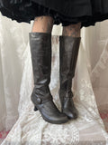 Black leather knee high boots with buckle detail