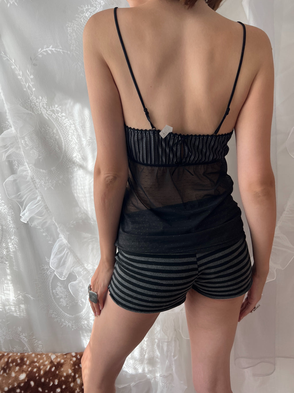 Black lace cami top with sheer mesh overlay and adjustable straps
