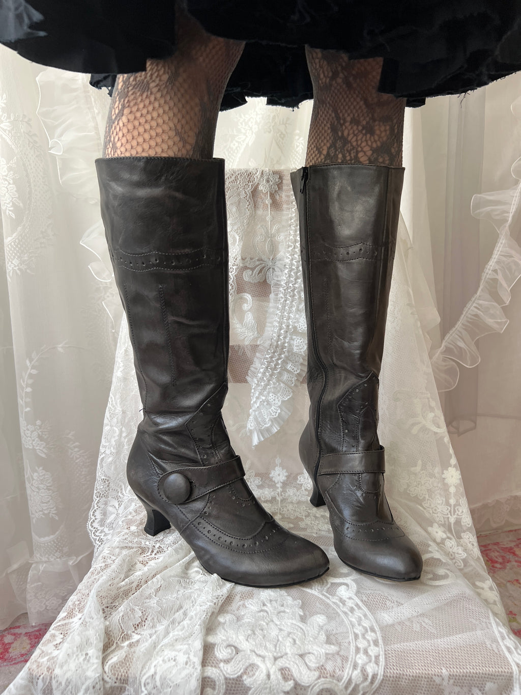 Black leather knee high boots with buckle detail