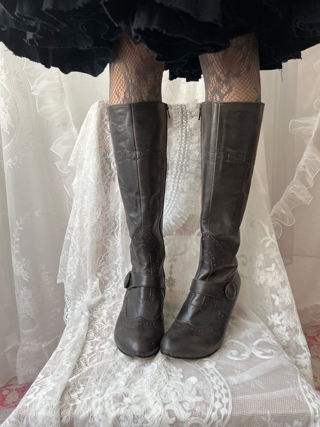 Black leather knee high boots with buckle detail