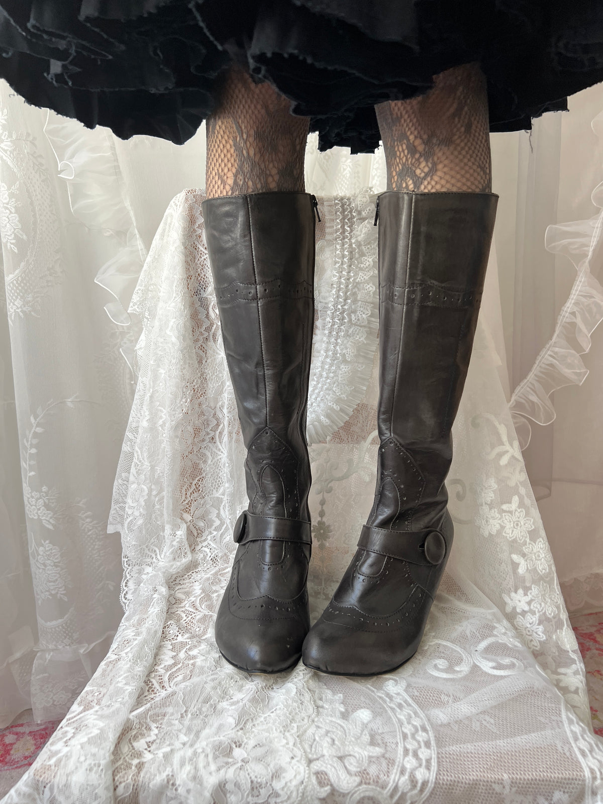 Black leather knee high boots with buckle detail