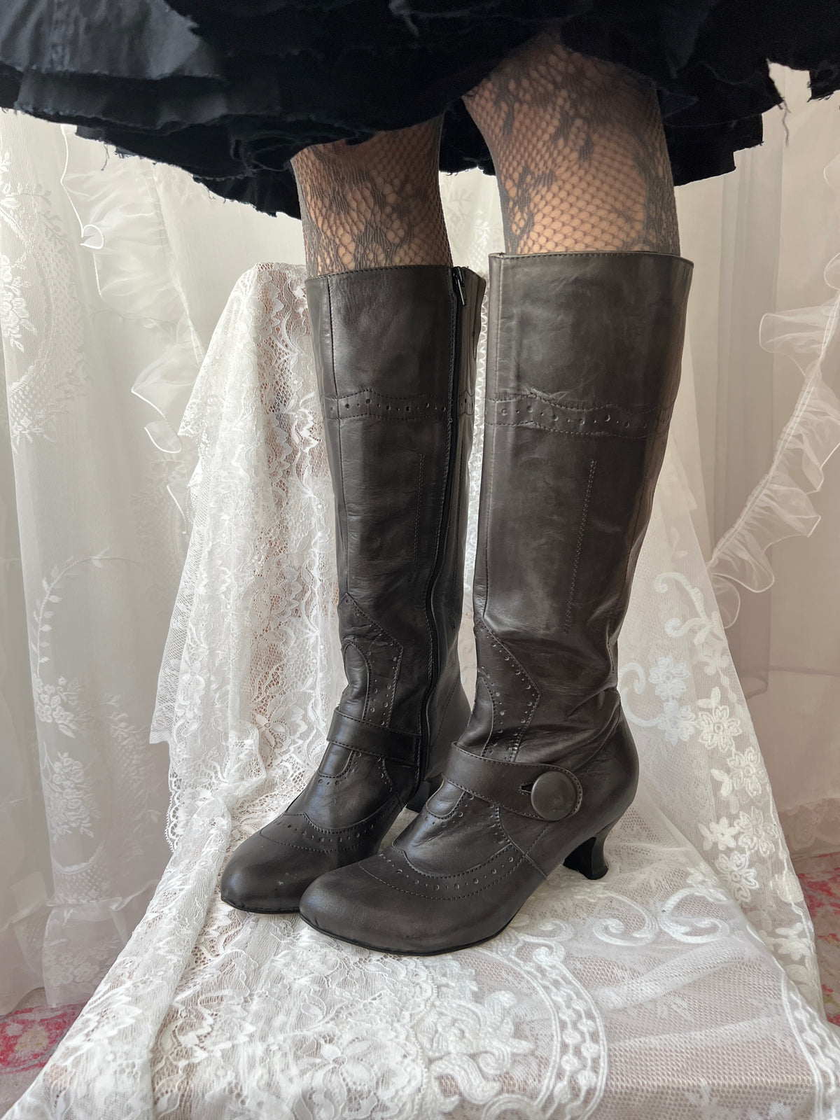 Black leather knee high boots with buckle detail