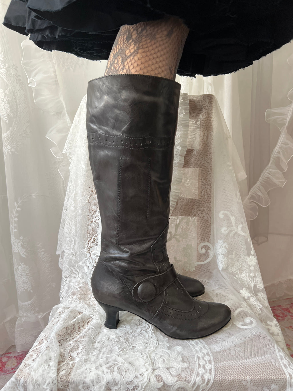 Black leather knee high boots with buckle detail