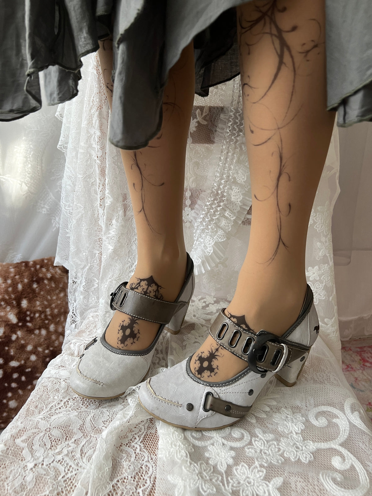 White Mustang heels with gray straps and buckles
