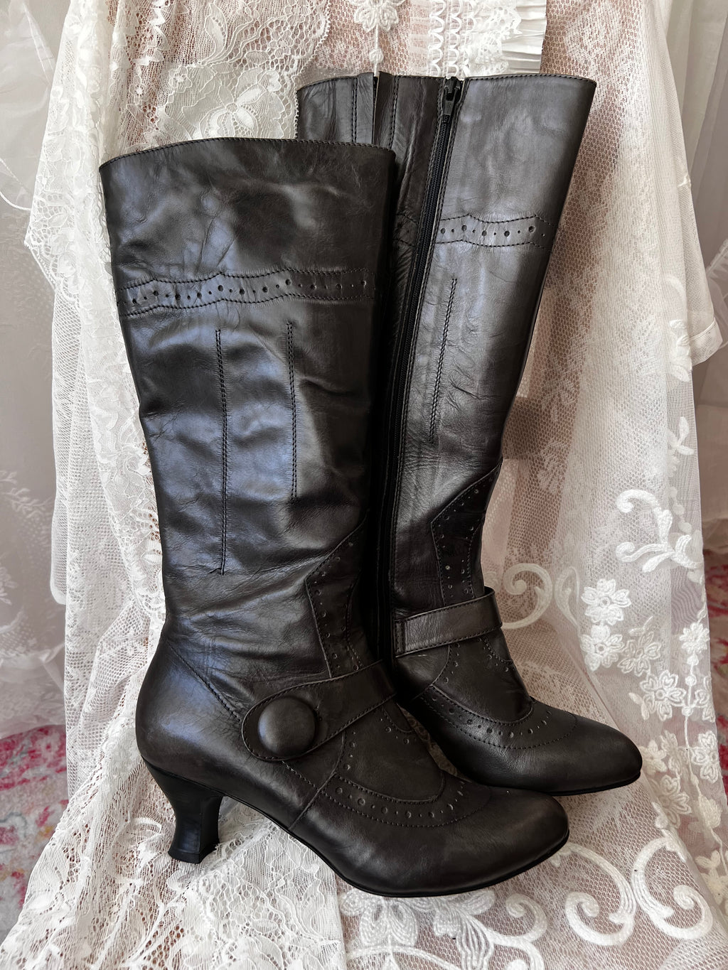 Black leather knee high boots with buckle detail