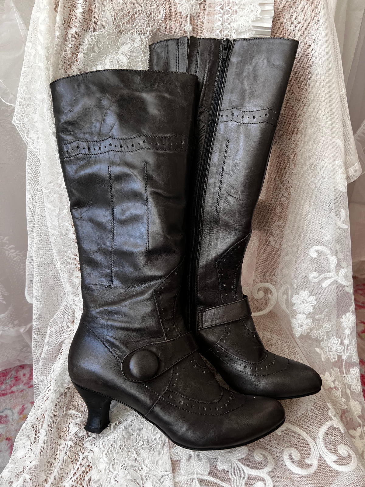 Black leather knee high boots with buckle detail