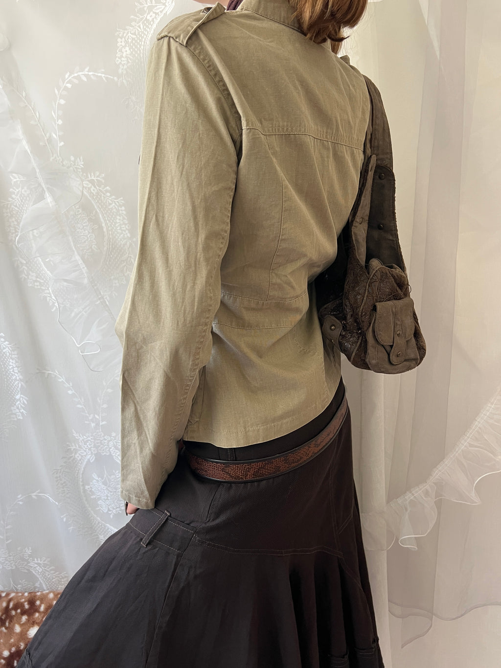 Khaki beige jacket with pockets, a zipper and a button-up front