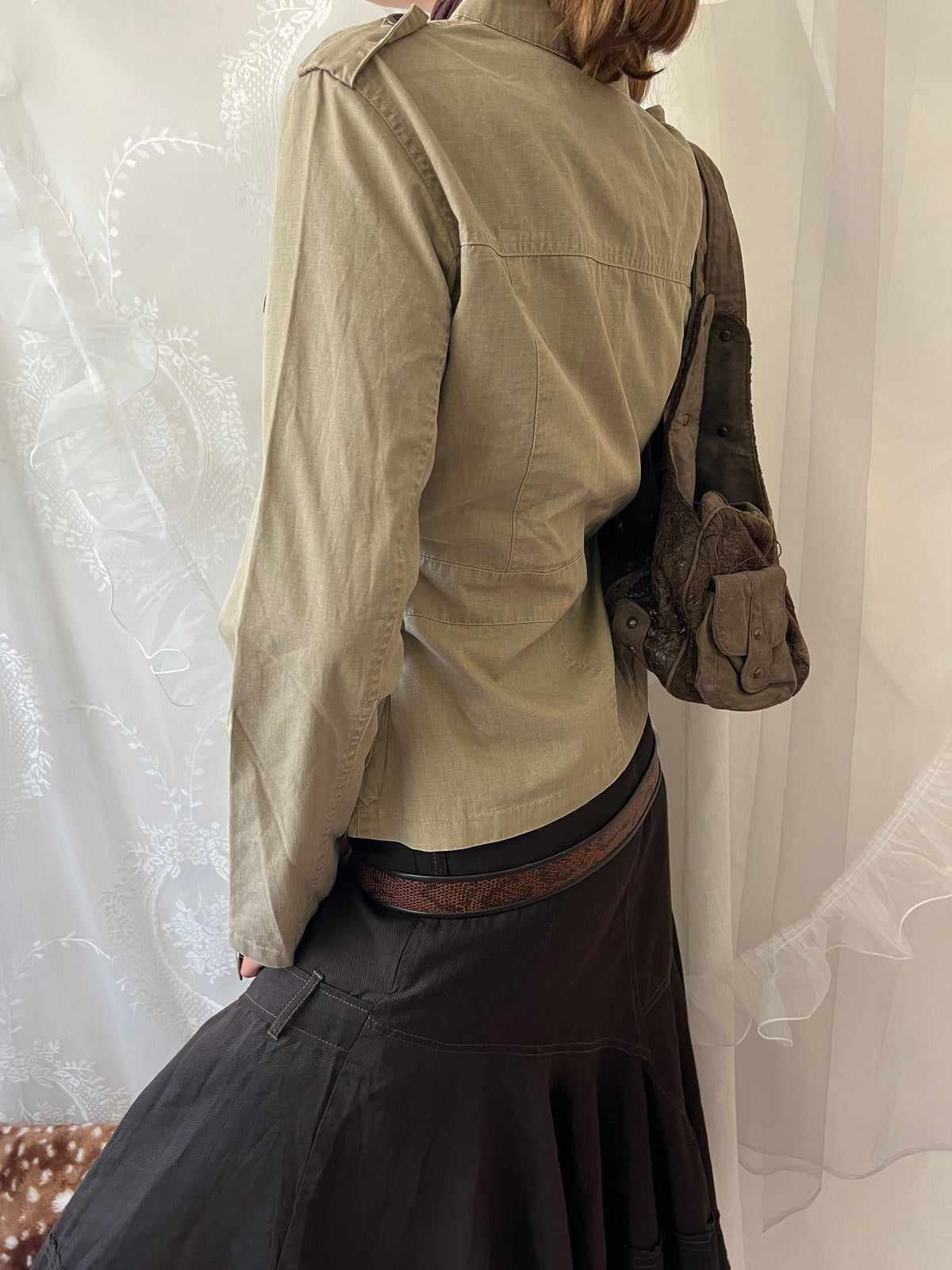 Khaki beige jacket with pockets, a zipper and a button-up front