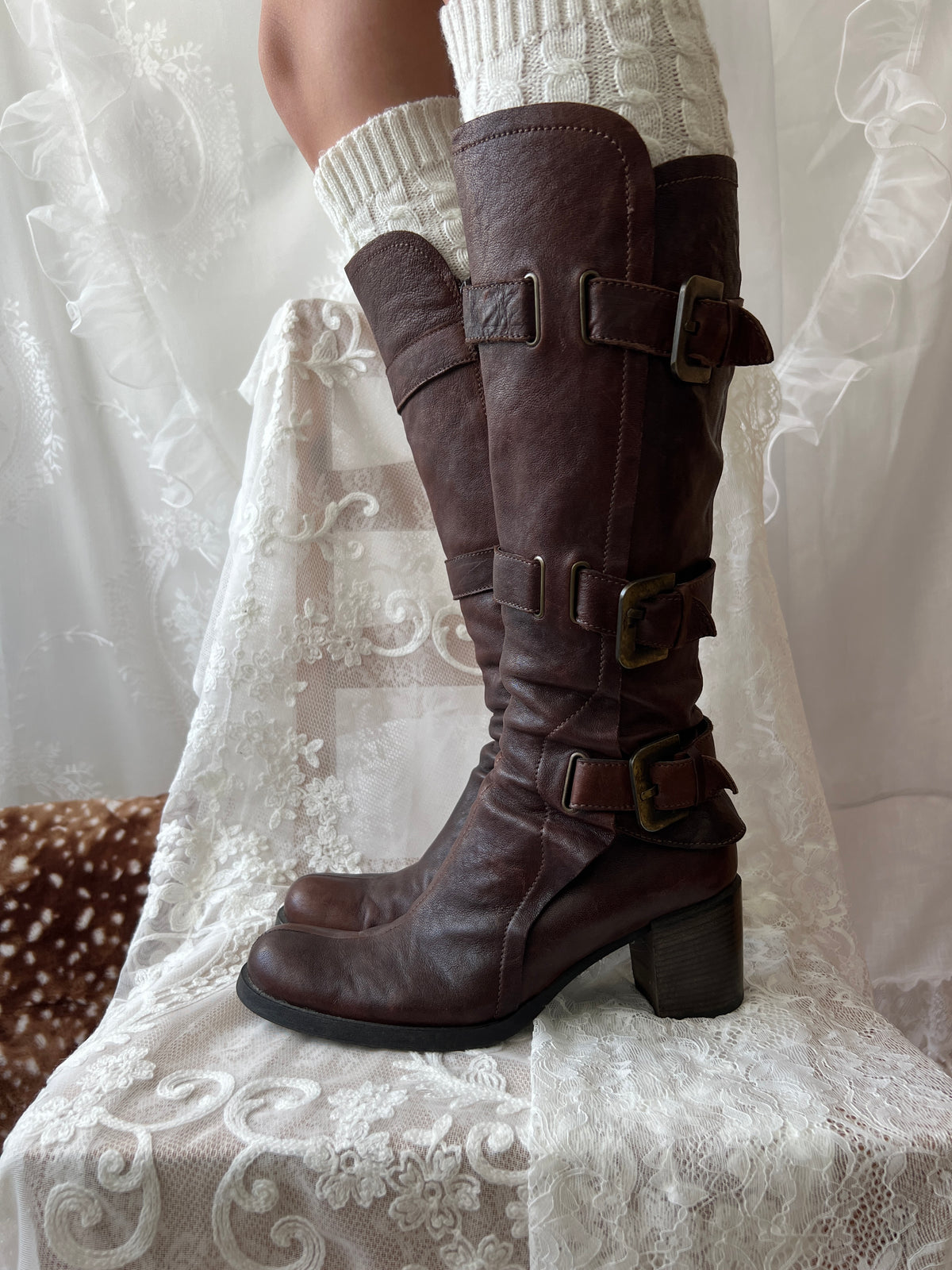 Brown knee high boots with buckle detail