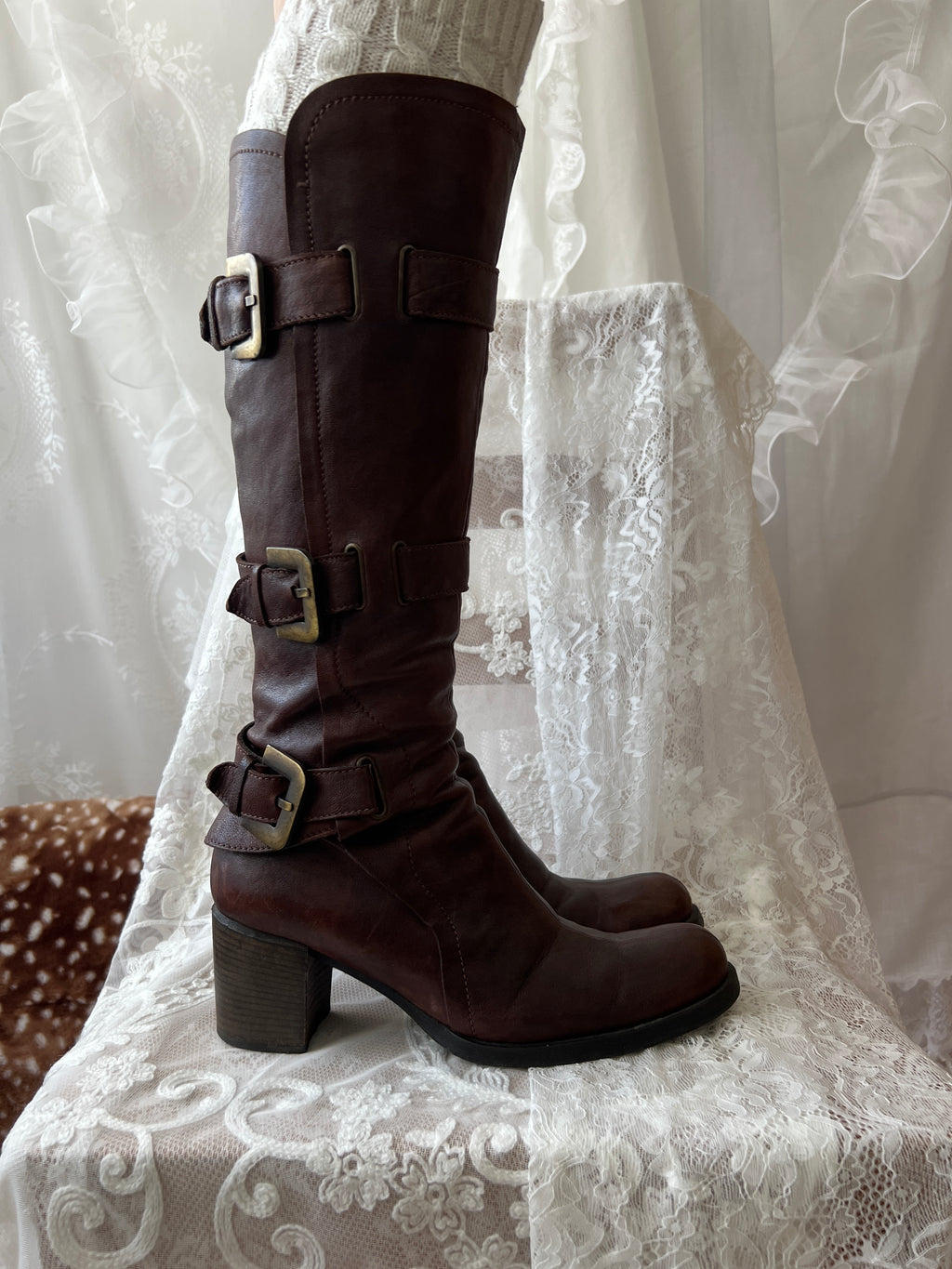 Brown knee high boots with buckle detail