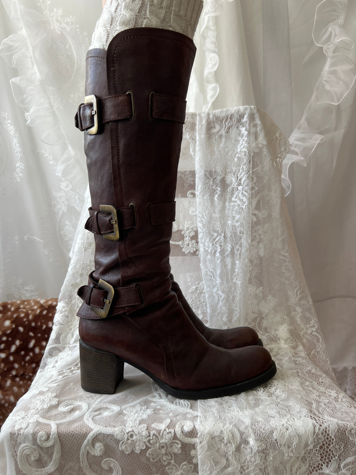 Brown knee high boots with buckle detail