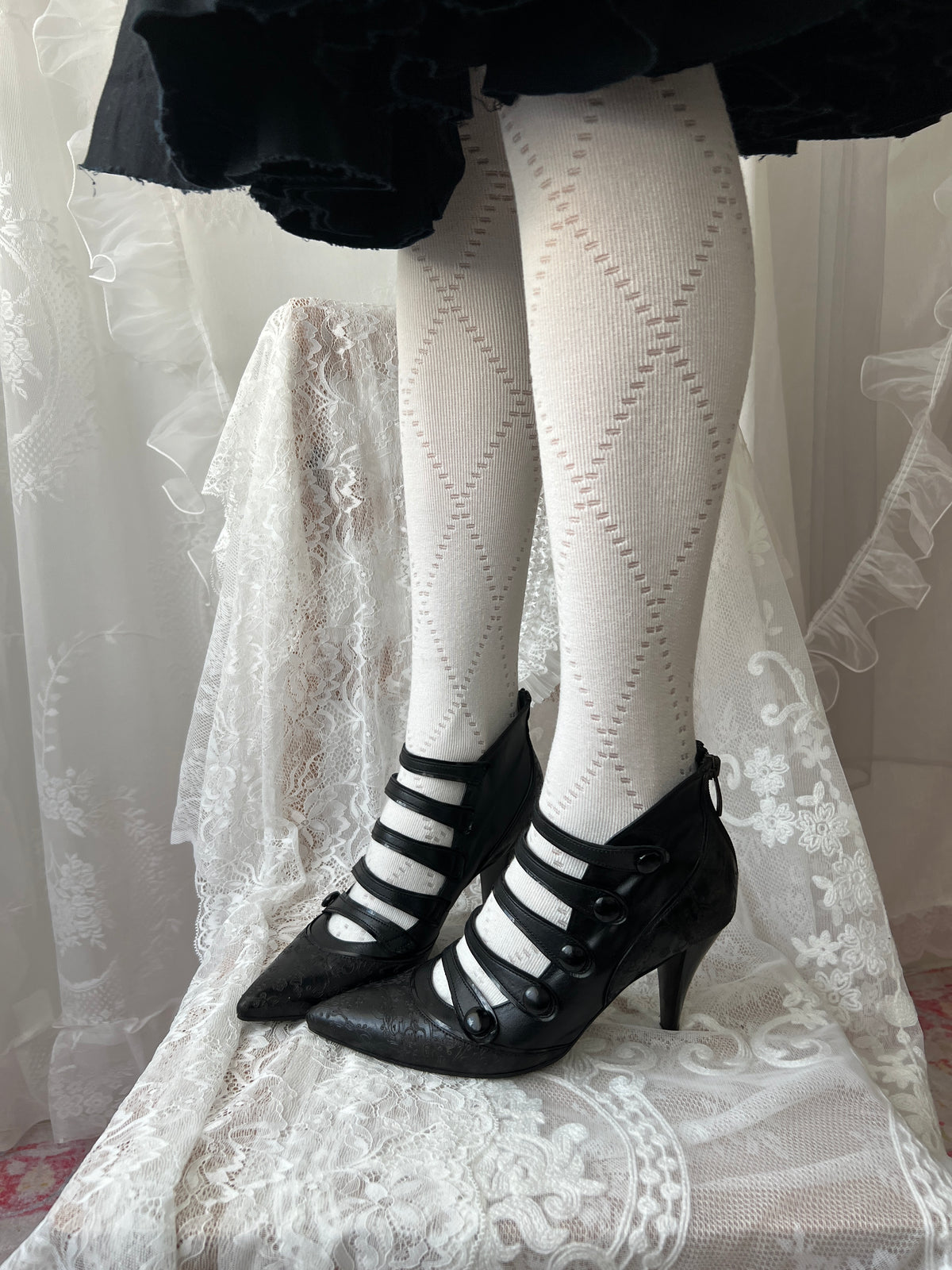 Black leather kitten heels with pointed toe and button details