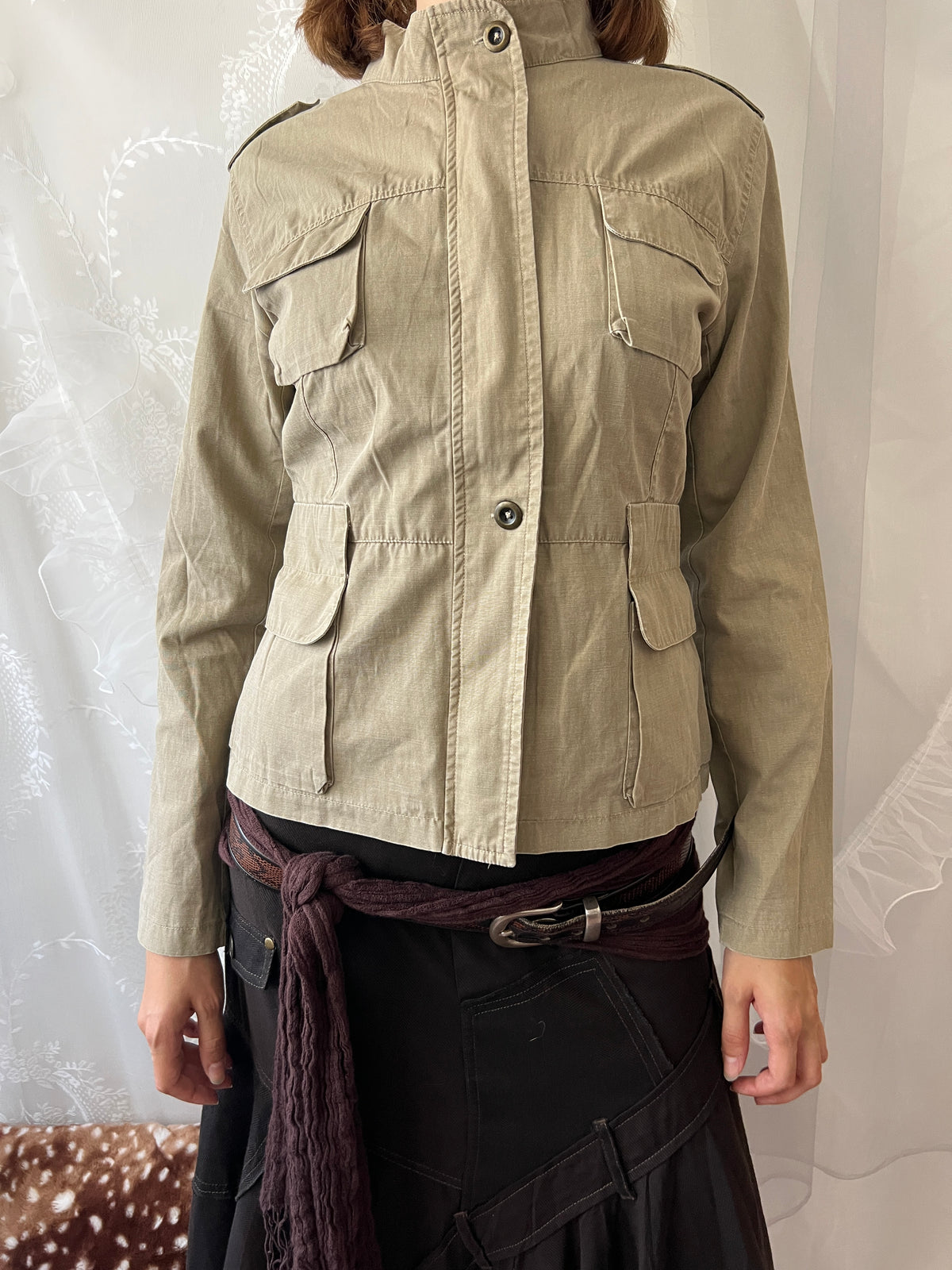 Khaki beige jacket with pockets, a zipper and a button-up front