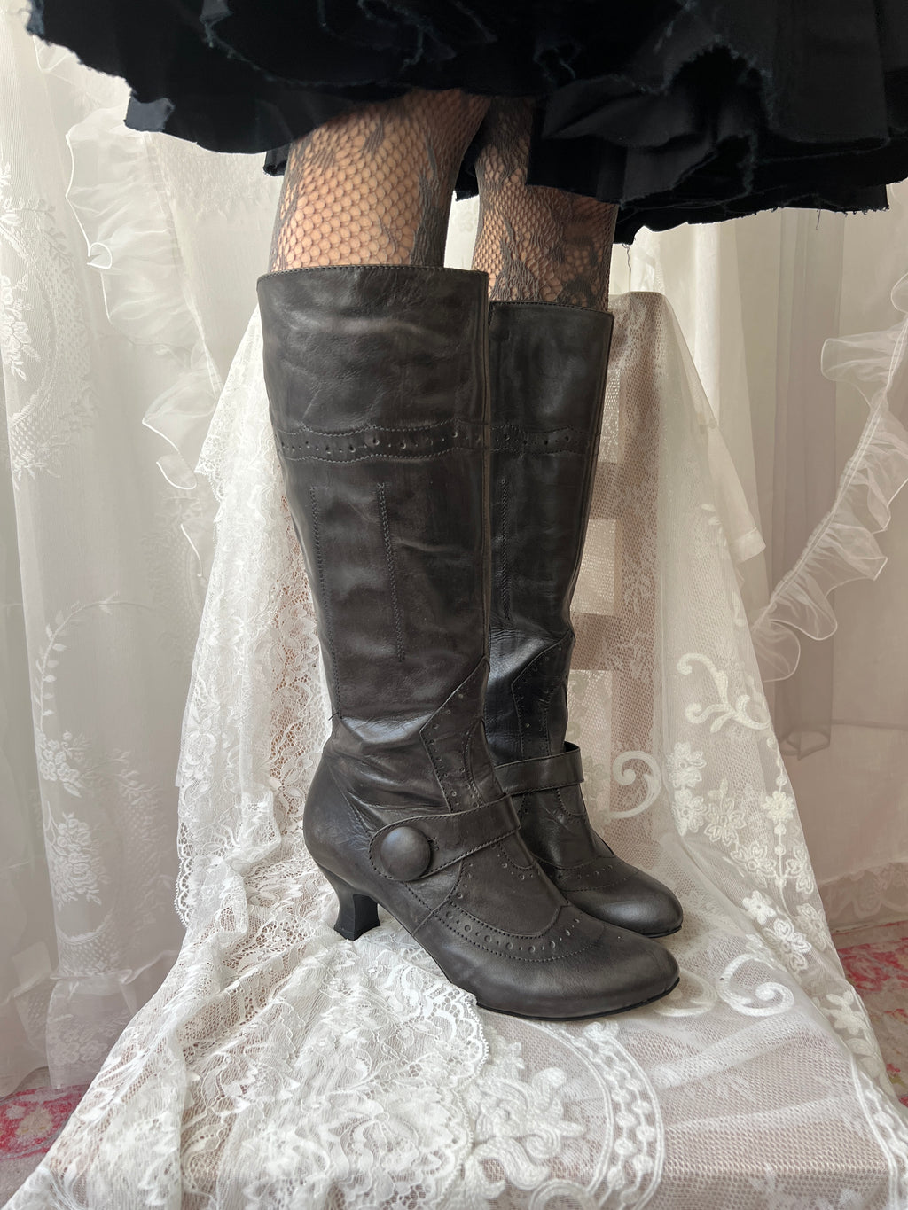 Black leather knee high boots with buckle detail