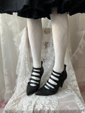 Black leather kitten heels with pointed toe and button details