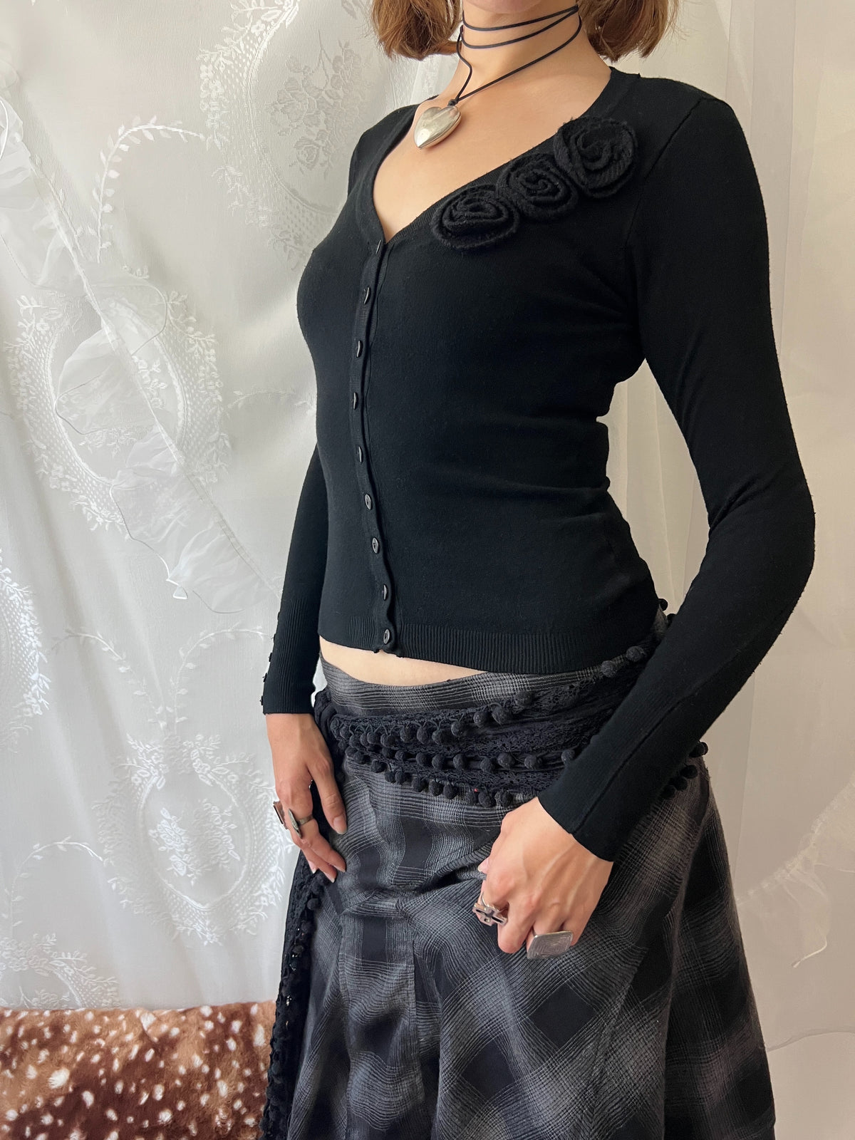 Black long sleeve top with button up front and flower detail