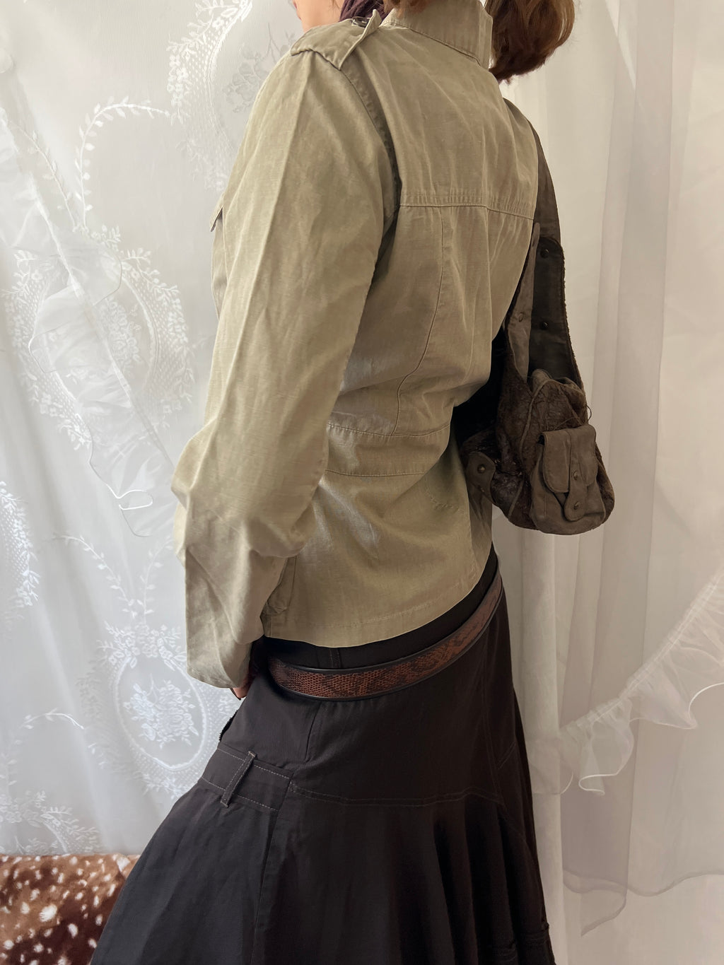 Khaki beige jacket with pockets, a zipper and a button-up front