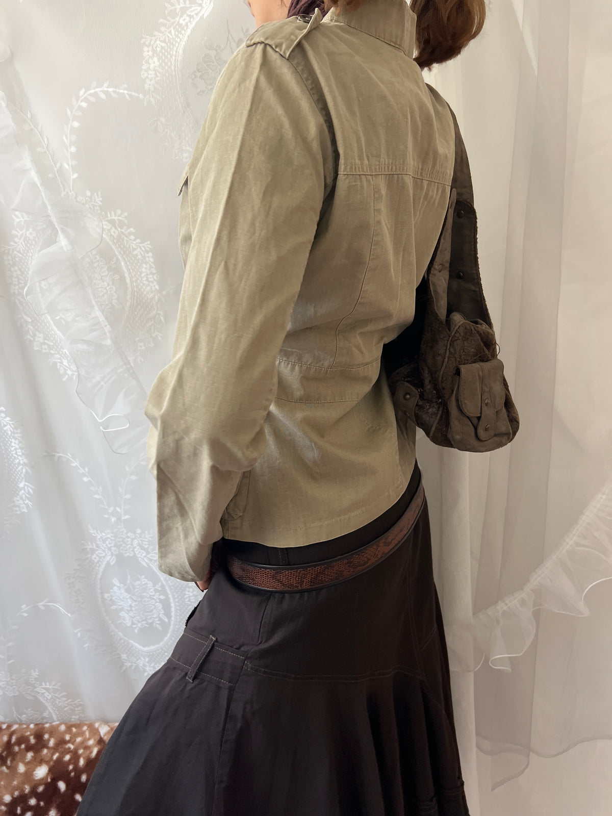 Khaki beige jacket with pockets, a zipper and a button-up front