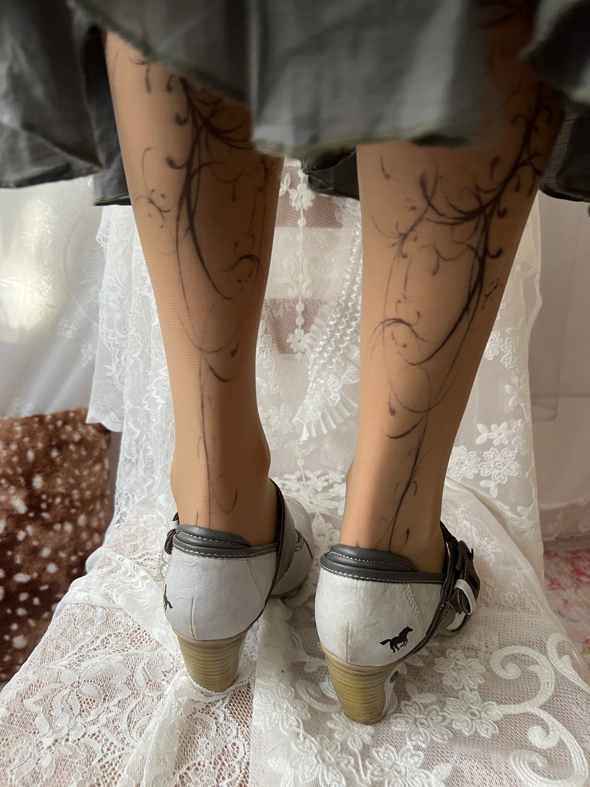 White Mustang heels with gray straps and buckles