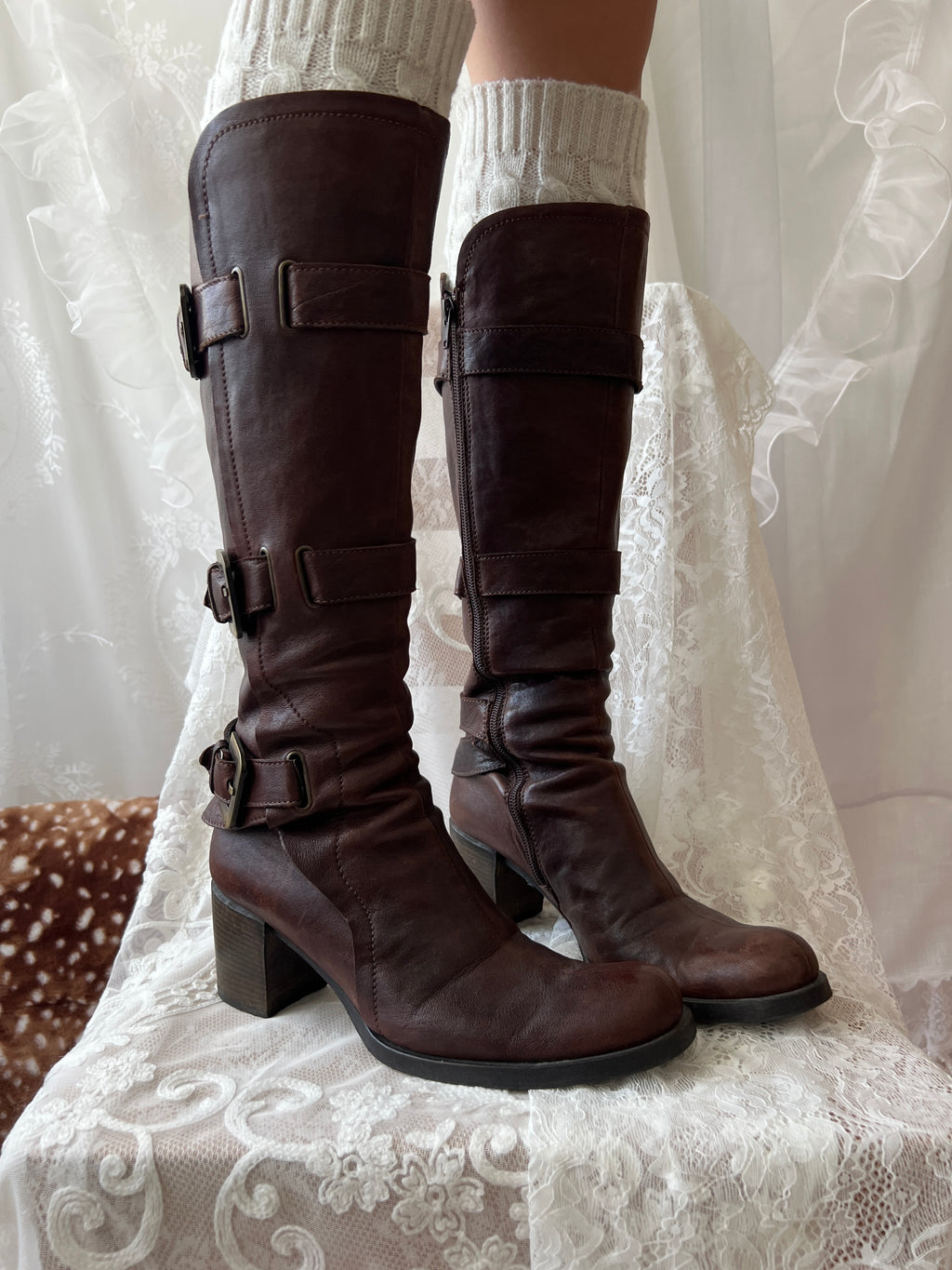 Brown knee high boots with buckle detail