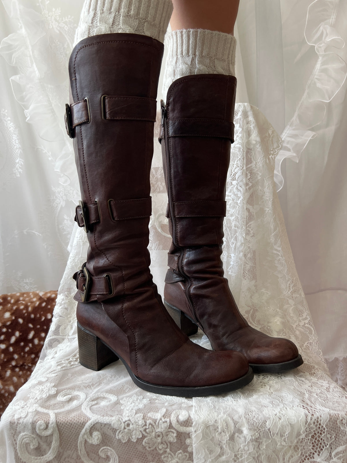 Brown knee high boots with buckle detail