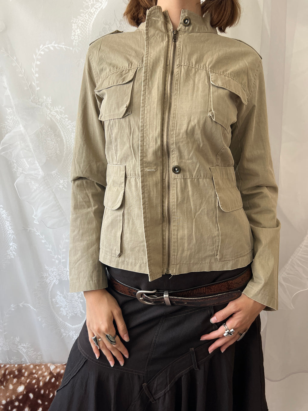 Khaki beige jacket with pockets, a zipper and a button-up front