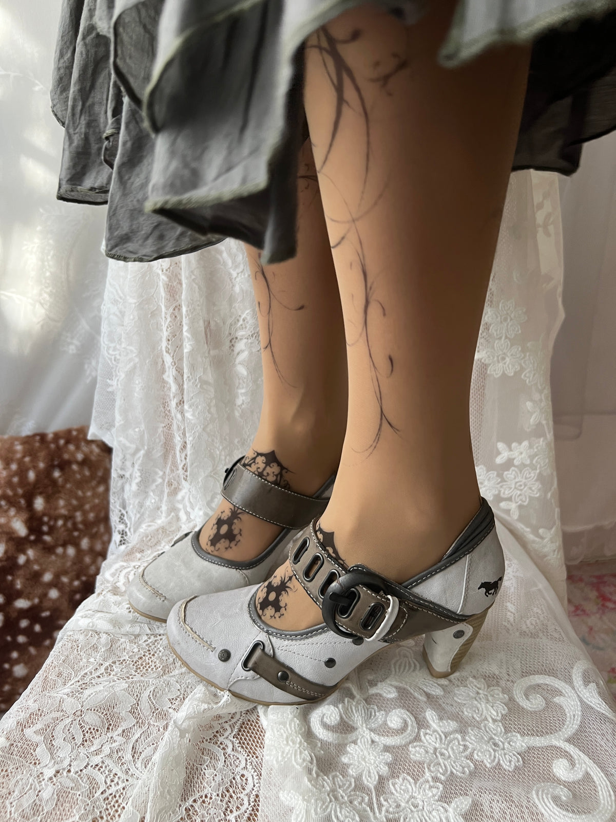 White Mustang heels with gray straps and buckles