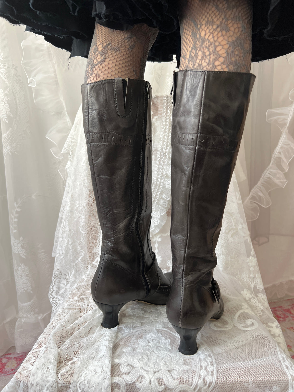 Black leather knee high boots with buckle detail