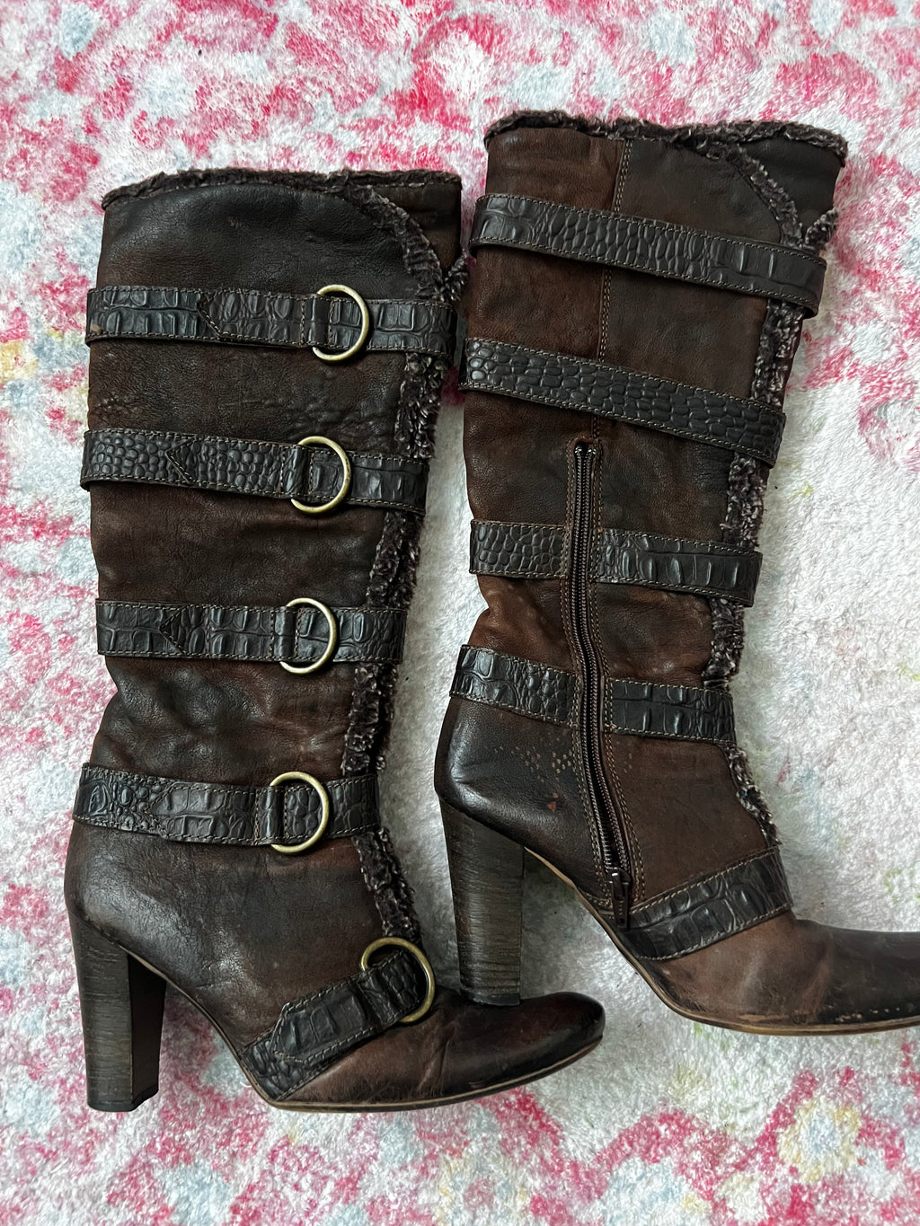Brown leather knee high boots with buckles and faux fur trim