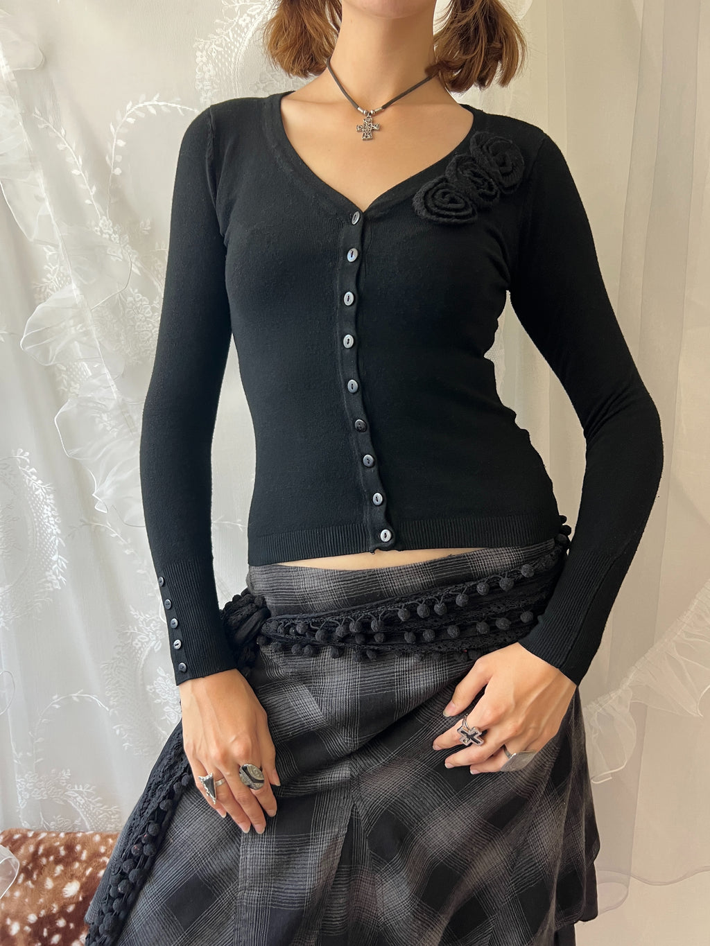Black long sleeve top with button up front and flower detail