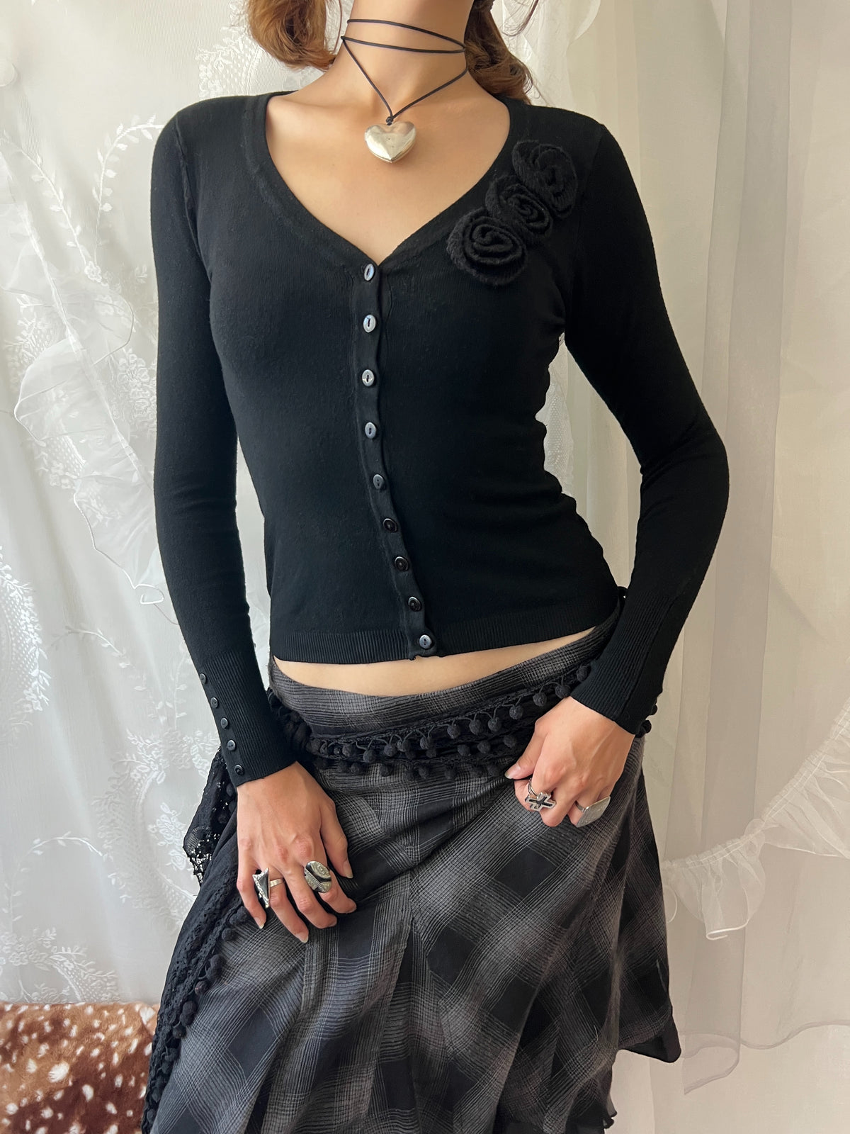 Black long sleeve top with button up front and flower detail