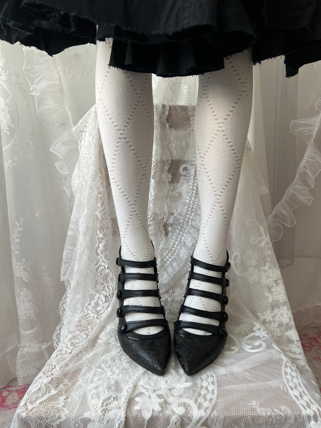 Black leather kitten heels with pointed toe and button details