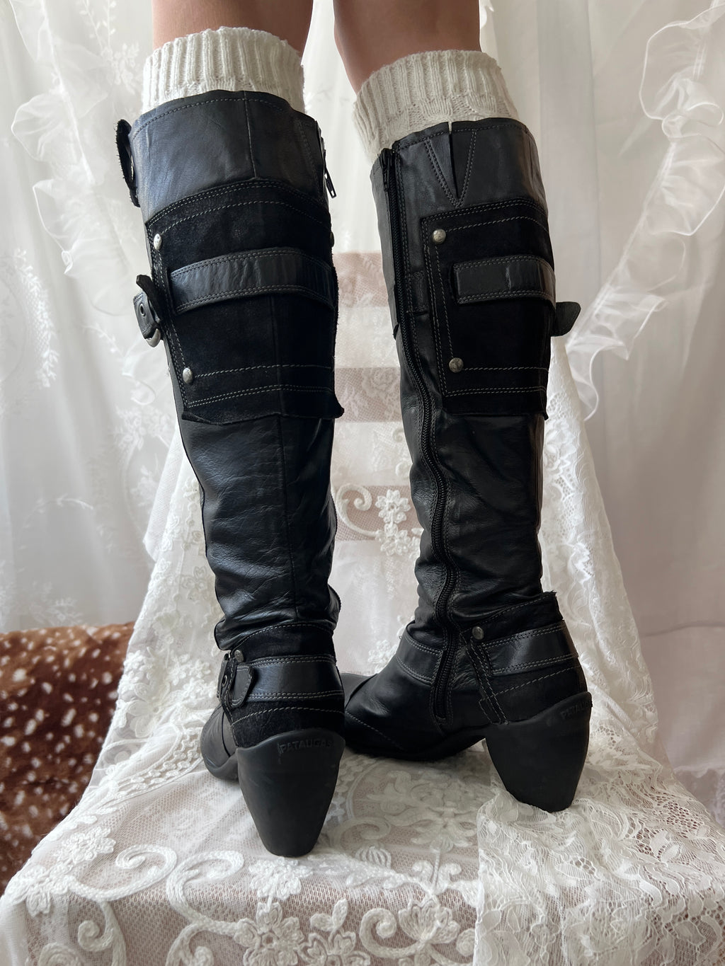Black knee high boots with silver buckles