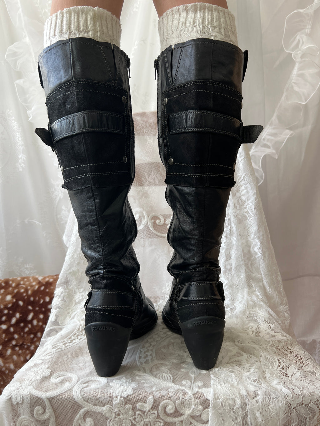 Black knee high boots with silver buckles