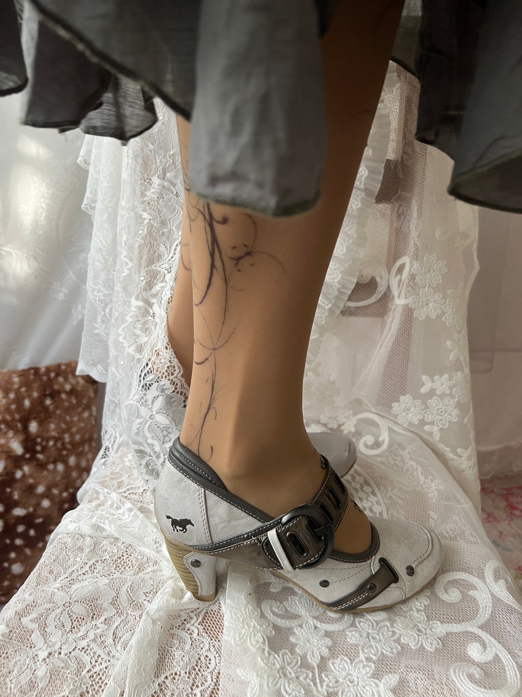 White Mustang heels with gray straps and buckles