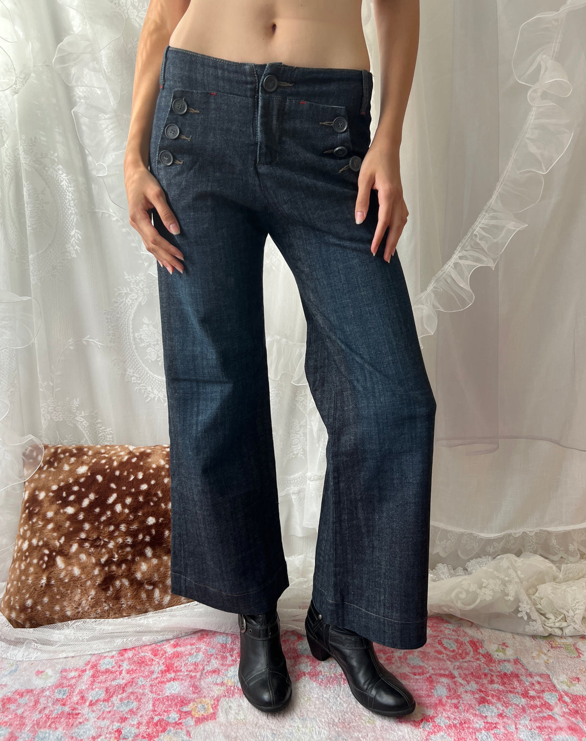 Dark wash denim jeans with button details and wide leg fit