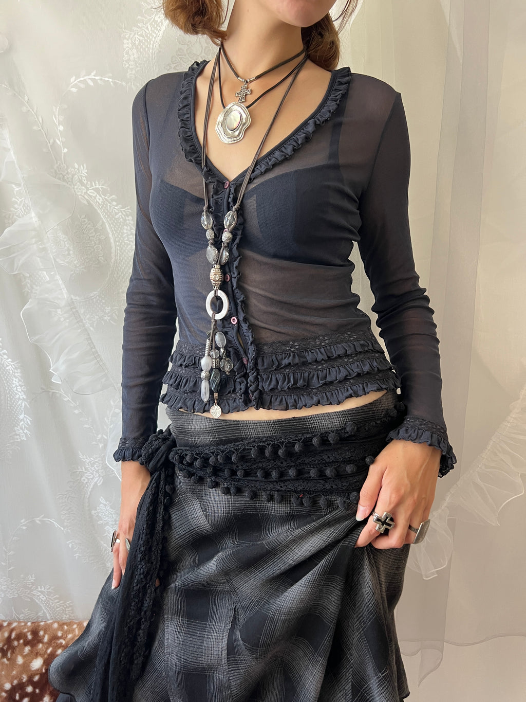 Dark blue sheer long sleeve top with ruffles and lace details