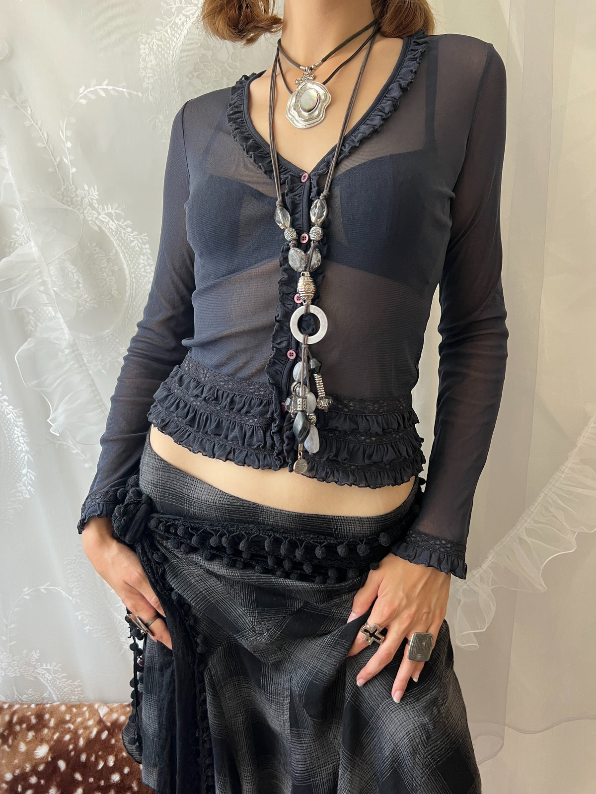 Dark blue sheer long sleeve top with ruffles and lace details