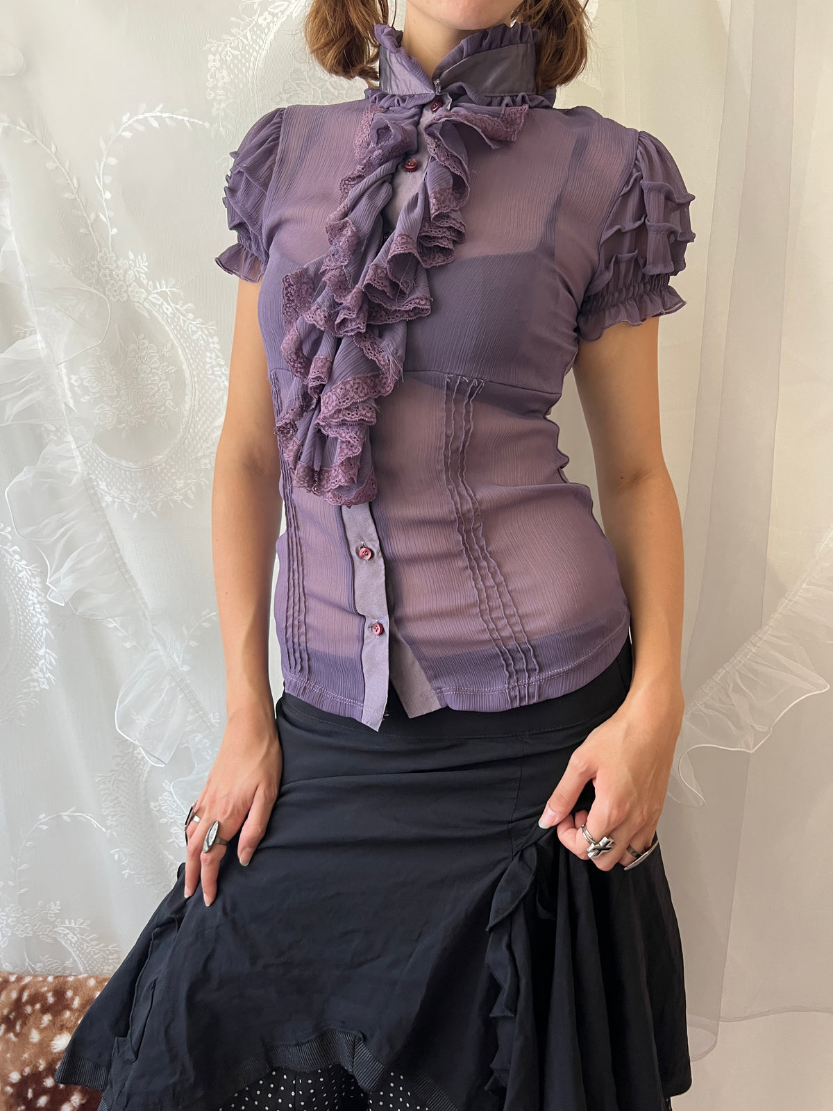 Purple sheer blouse with ruffles and lace details